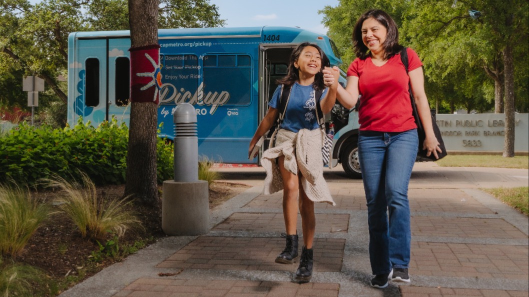 Photo of mother and daughter exiting Pickup vehicle outside library