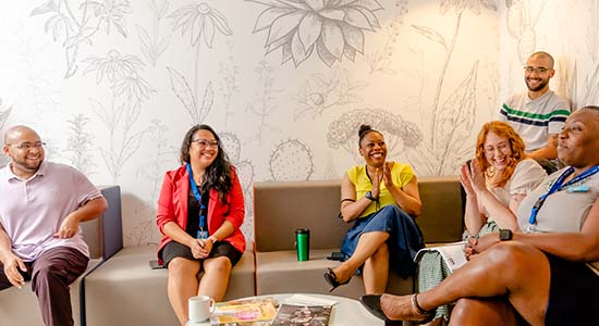 Diverse group of young women and men sitting in a conference room at CapitalMetro