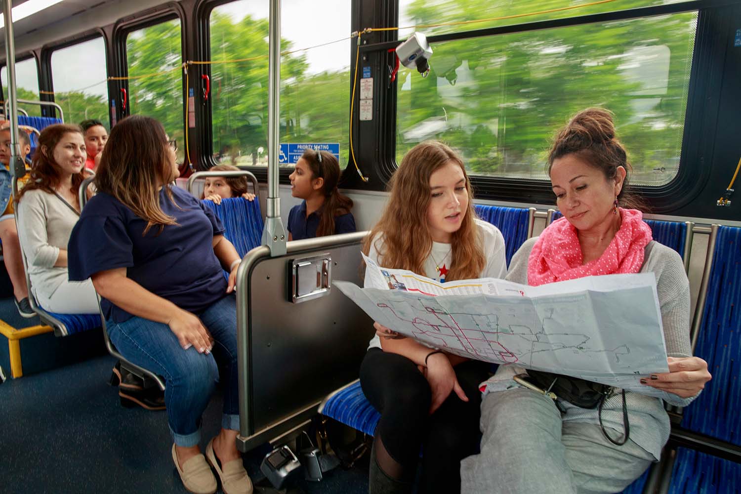 Kids on bus looking at map