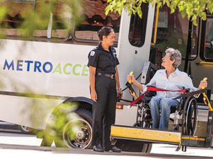 section1-MetroAccess-vehicle-operator-assisting-wheelchair-customer-de-boarding