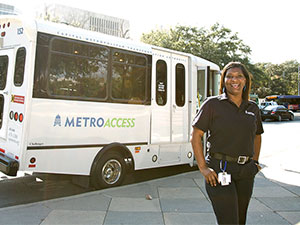 section7-MetroAccess-vehicle-operator-with-her-vehicle-in-the-background