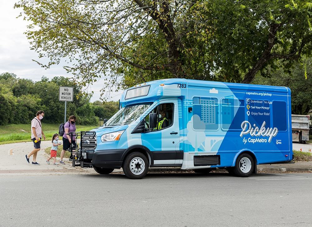 Blue Pickup Vehicle in action picking up passengers